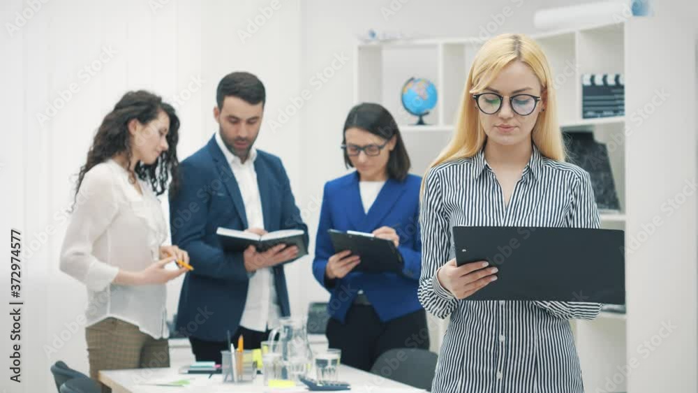 4k slowmotion video of female director standing in front of her collegues. 4k slowmotion video of female director standing in front of her collegues.