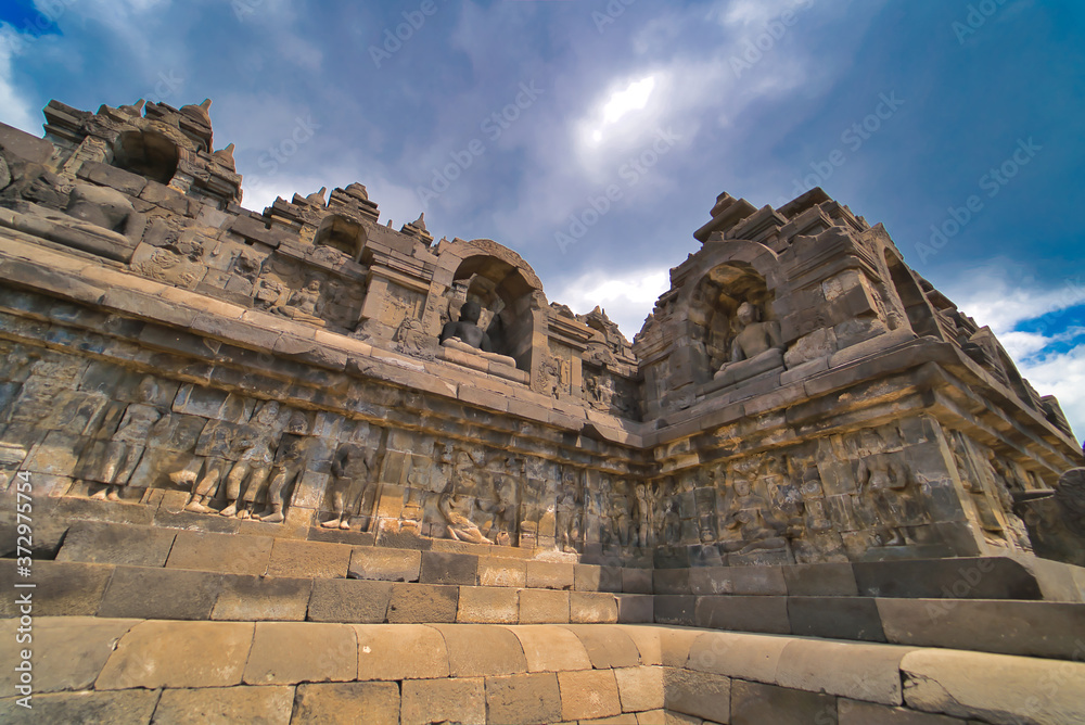 Fototapeta premium Buddha statue in Buddist temple of Borobudur in the morning. Yogyakarta. Java, Indonesia.