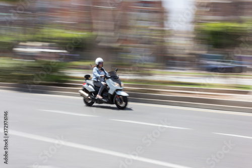 Motorcycle moving through the city. © lamechakearde
