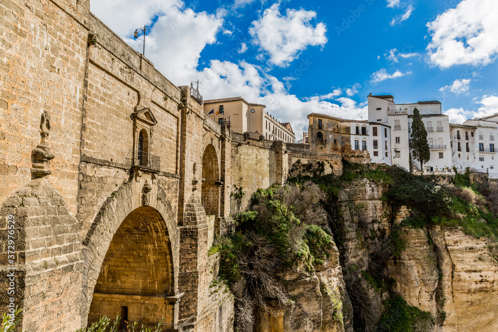 New Bridge (Puente Nuevo) over the Guadalevín River and a small part of the city of Ronda on the plateau, wonderful view of the Tagus de Ronda on a sunny day in the province of Malaga, Spain