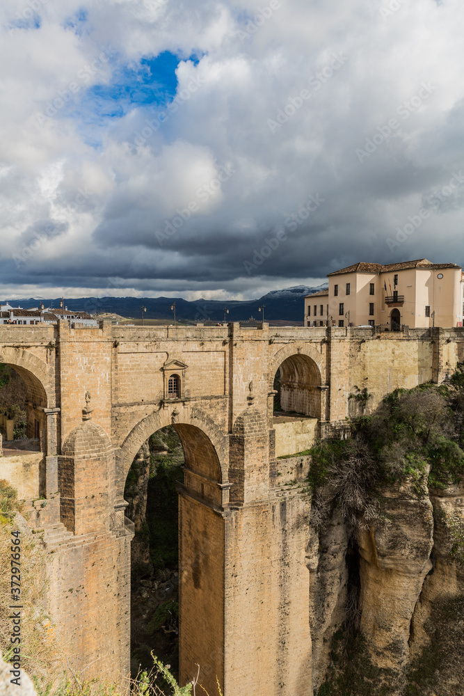 Tajo de Ronda and the Puente Nuevo (New Bridge) over the Guadalevín river, an incredible view on a cloudy day with heavy clouds in the province of Malaga, Spain