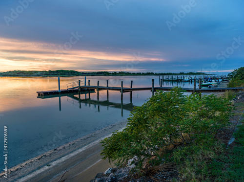 Lagoon landscape at dawn with wooden jetty © oscar0