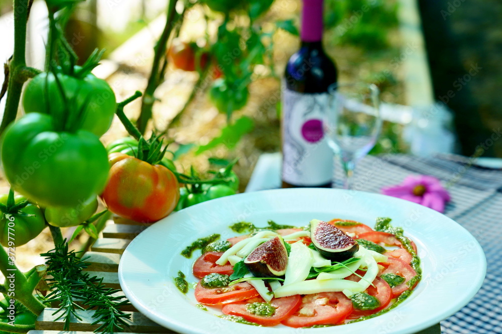 tomato carpaccio with figs served in a ecological vegetable garden
