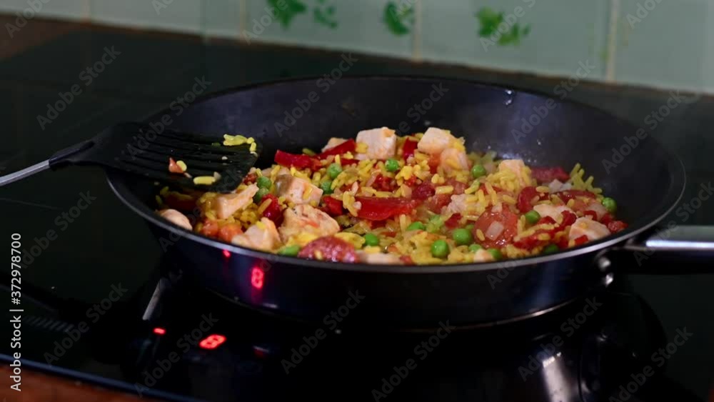 chicken chorizo cooking in frying pan giving off steam.