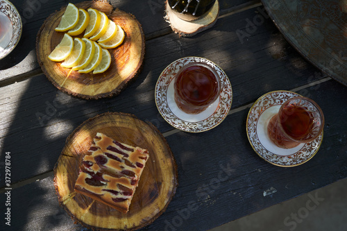 Breakfast table with apple pie, tea glass, outdoors. Homemade Apple Pie