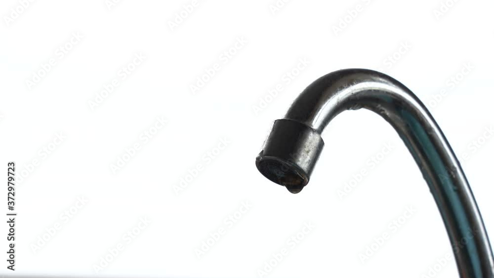 Tap water dripping. Plumbing chromed old mixer isolated on white background. Waste drops of water. Water drips from the tap. copy space. Tap water dripping. Plumbing chromed old mixer isolated on white background. Waste drops of water. Water drips from the tap. copy space.
