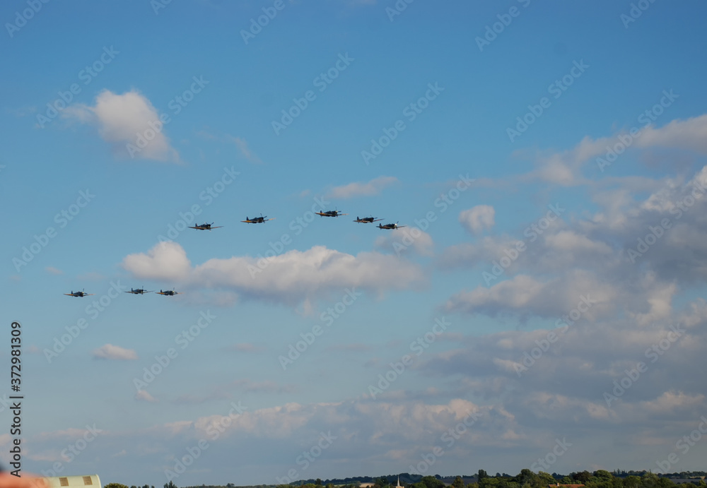 Fototapeta premium A flight of World War II era Supermarine Spitfires perform a fly past