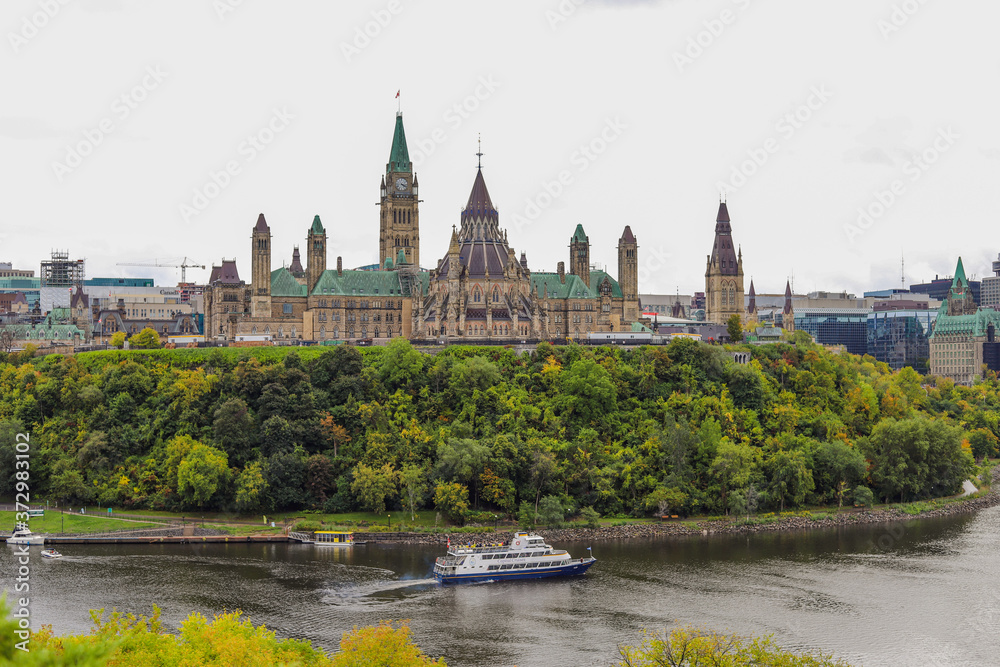 Parliament Hill, Ottawa, Rideau canal. Cruise ship. Cloudy sky in Autumn city Parliament Hill, Ottawa, Rideau canal. Cruise ship. Cloudy sky in Autumn city