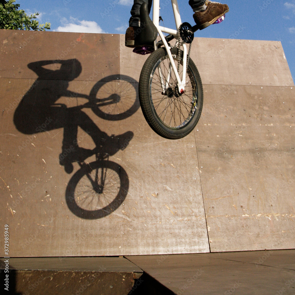 shadow on a wall in a skatepark showing a bmx rider performing a huge ...
