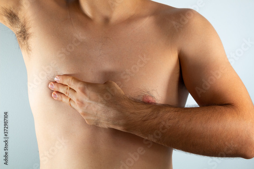 close up of a man s chest looking for signs of male breast cancer