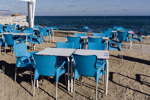 terrace tables of a beach bar emptied by coronavirus  COVID-19 