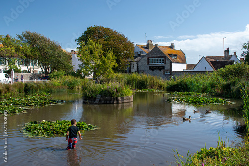 The pretty pond in a scenic setting in the coastal village of Rottingdean situated near Brighton. photo