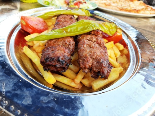 delicious Adana kebab and salads