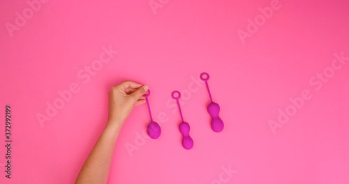 woman holds a kegel trainer. Latex vaginal vibrator for training the pelvic floor muscles with an antenna. The device for imbuilding. Women Health. High quality . Copy space. Banner © Marina