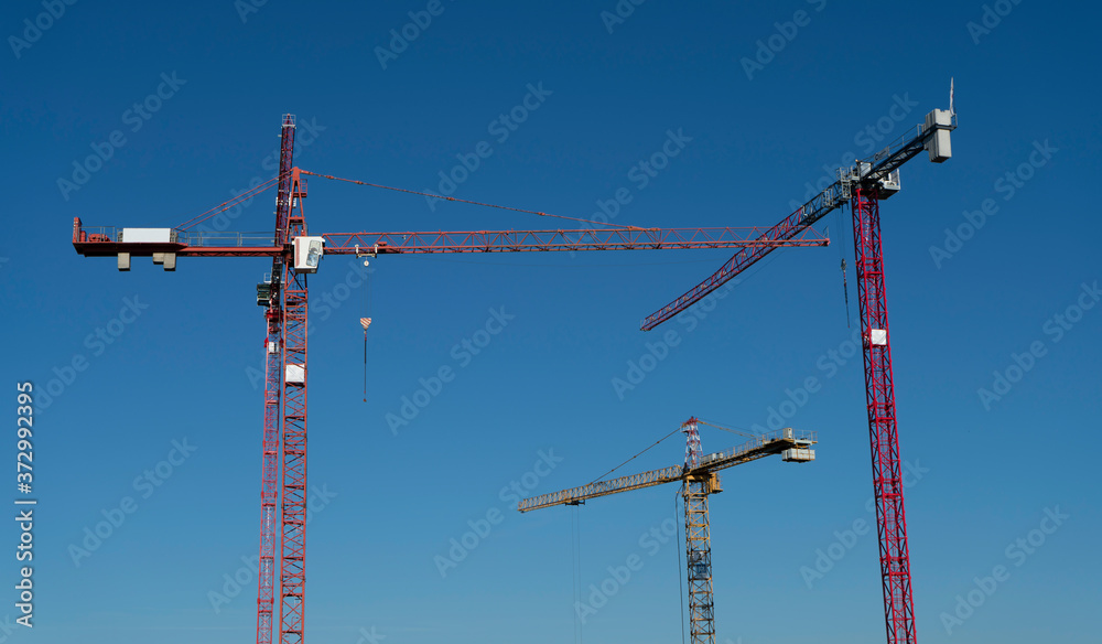 tower cranes and blue sky tower cranes and blue sky