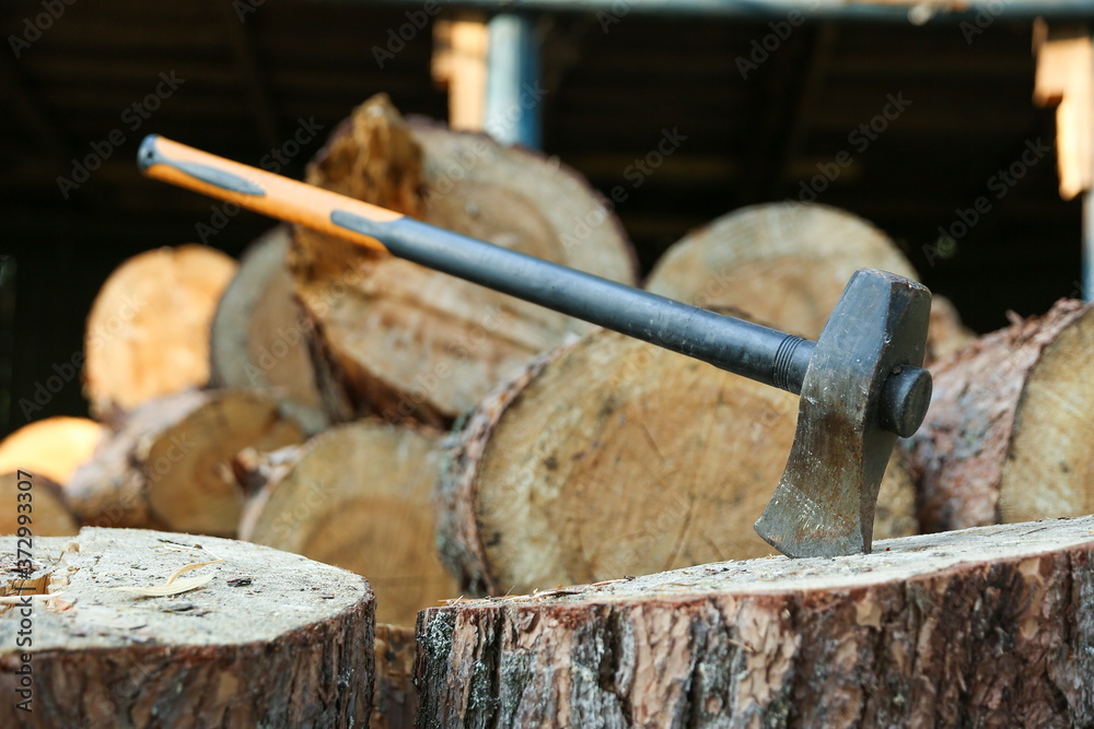 ax on a background of wooden firewood ax on a background of wooden firewood