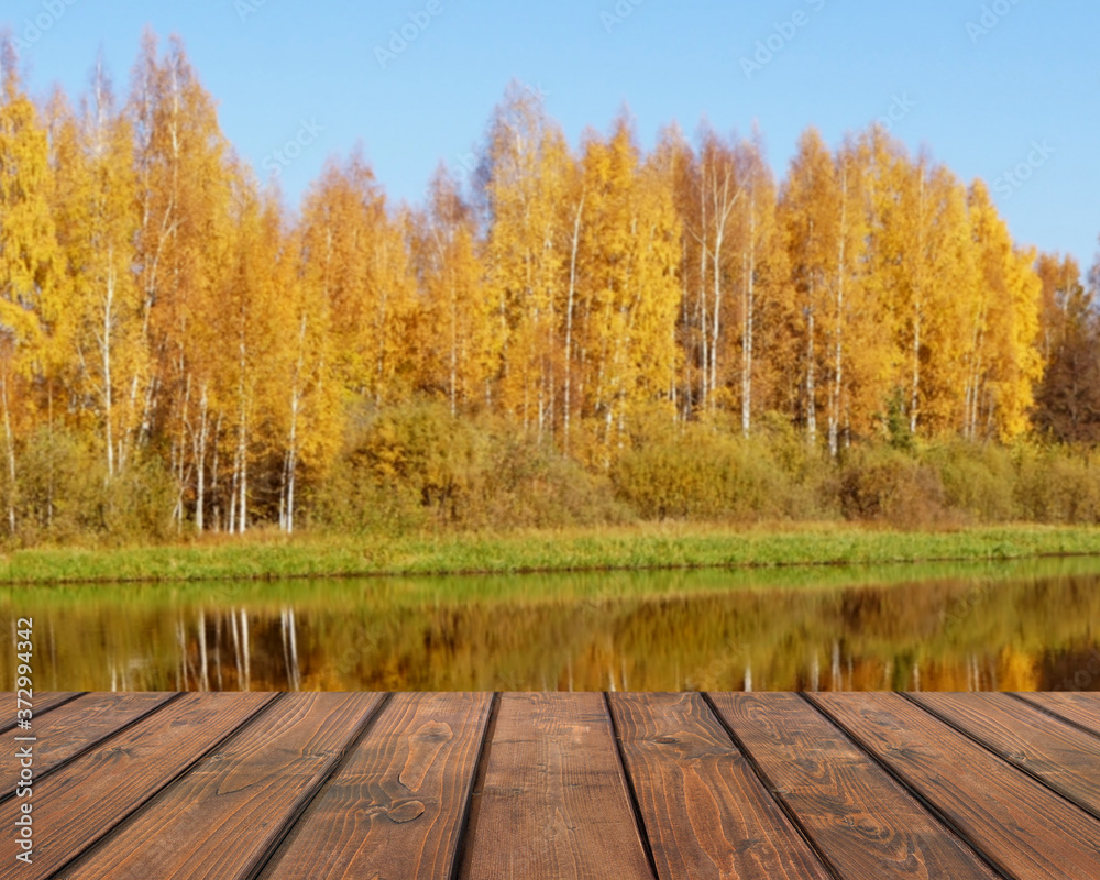 Empty wooden table on a autumn blurred background. Empty wooden table on a autumn blurred background.