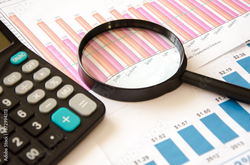 Magnifier calculator lies on a color chart. financial responsibility