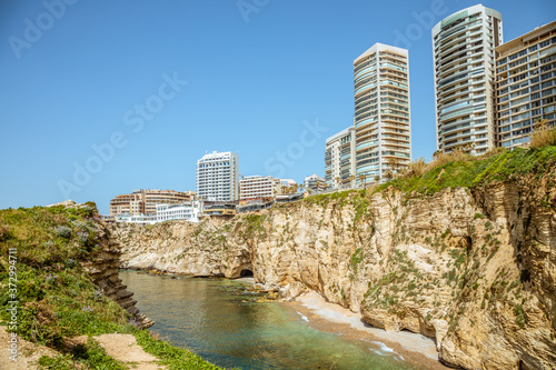 Downtown buildings and towers with rocks and sea in the foreground  Beirut  Lebanon