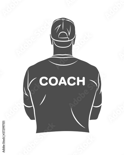 Fényképezés Silhouette sports coach stands with his back in a T-shirt and baseball cap