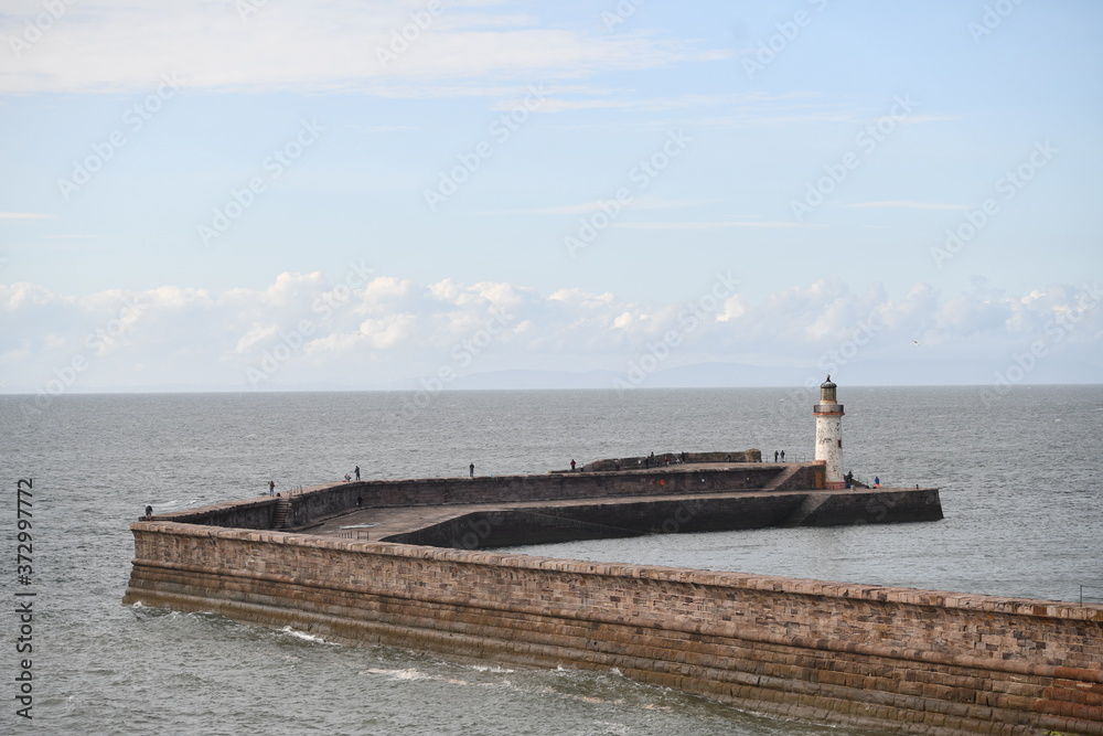 Fototapeta premium man walking on the pier