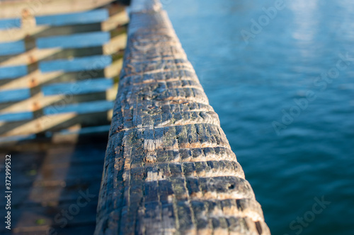 Wear grooves in the wood railing, made by people tying their crab pots to the rail on a pier in Newport Oregon.