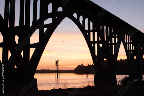 View of a beautiful pastel sunset from under the historic Newport Oregon bridge.