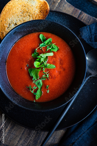 Gazpacho soup served in black bowl