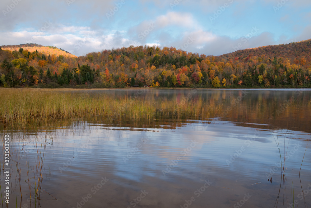 Fall scene on Connery Pond with mountains and water  in the Adirondacks, New York