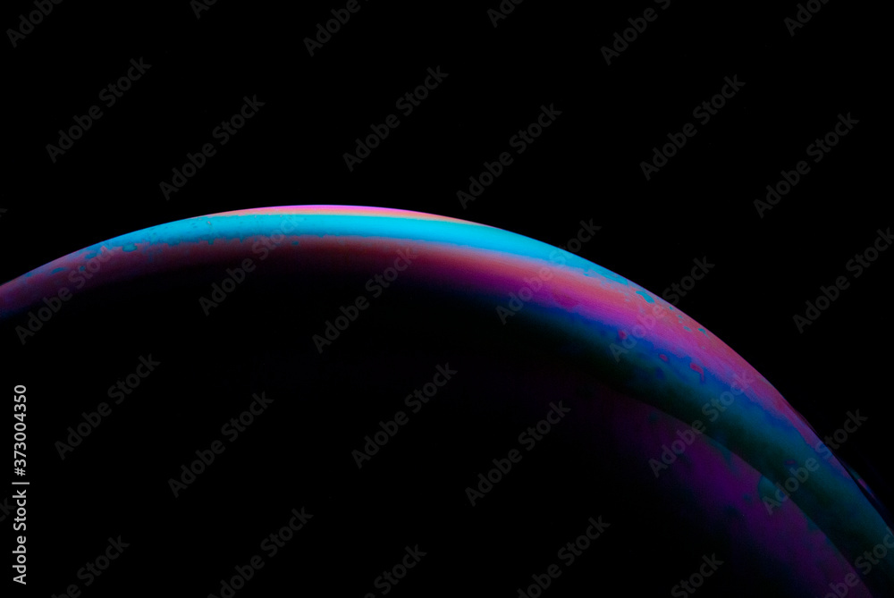 Detail of light in a soap bubble, allusion to the micro universe in a studio with a black background, use of natural and artificial light. Detail of light in a soap bubble, allusion to the micro universe in a studio with a black background, use of natural and artificial light.