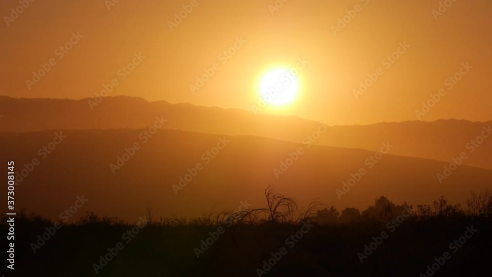 Pan right darker WS Sunrise in Palm Springs, CA with tree Pan right darker WS Sunrise in Palm Springs, CA with tree