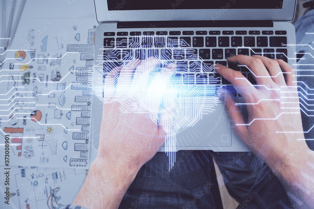 Double exposure of man's hands typing over computer keyboard and brain hologram drawing. Top view. Ai and data technology concept. Double exposure of man's hands typing over computer keyboard and brain hologram drawing. Top view. Ai and data technology concept.