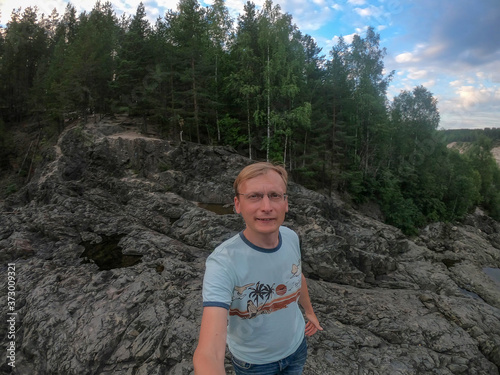 man stands on stones geological object the most ancient volcano crater in Karelia Russia  photo