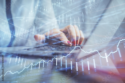 Wallpaper Mural Double exposure of businesswoman hands typing on computer and financial graph hologram drawing. Stock market analysis concept. Torontodigital.ca