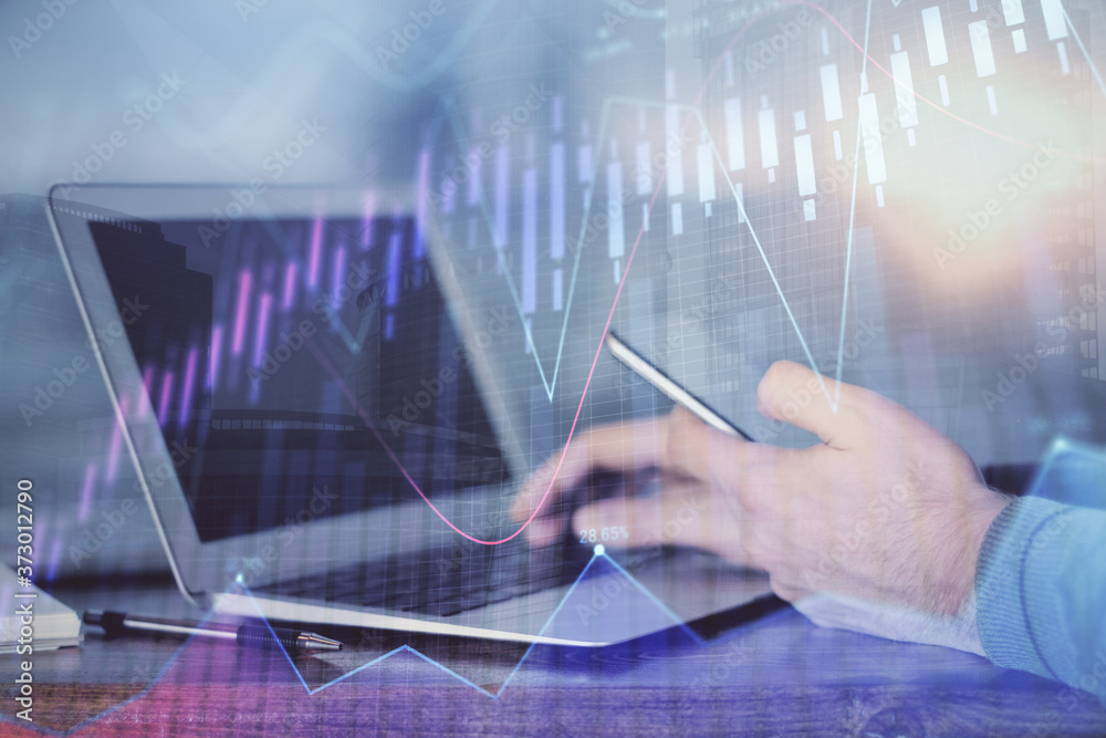 Double exposure of man's hands holding and using a digital device and forex graph drawing. Financial market concept. Double exposure of man's hands holding and using a digital device and forex graph drawing. Financial market concept.