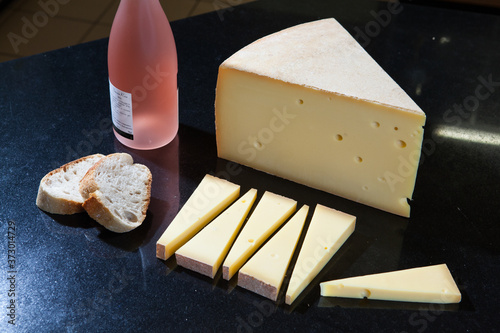 Closeup shot of French Gruyere cheese and baguette bread photo