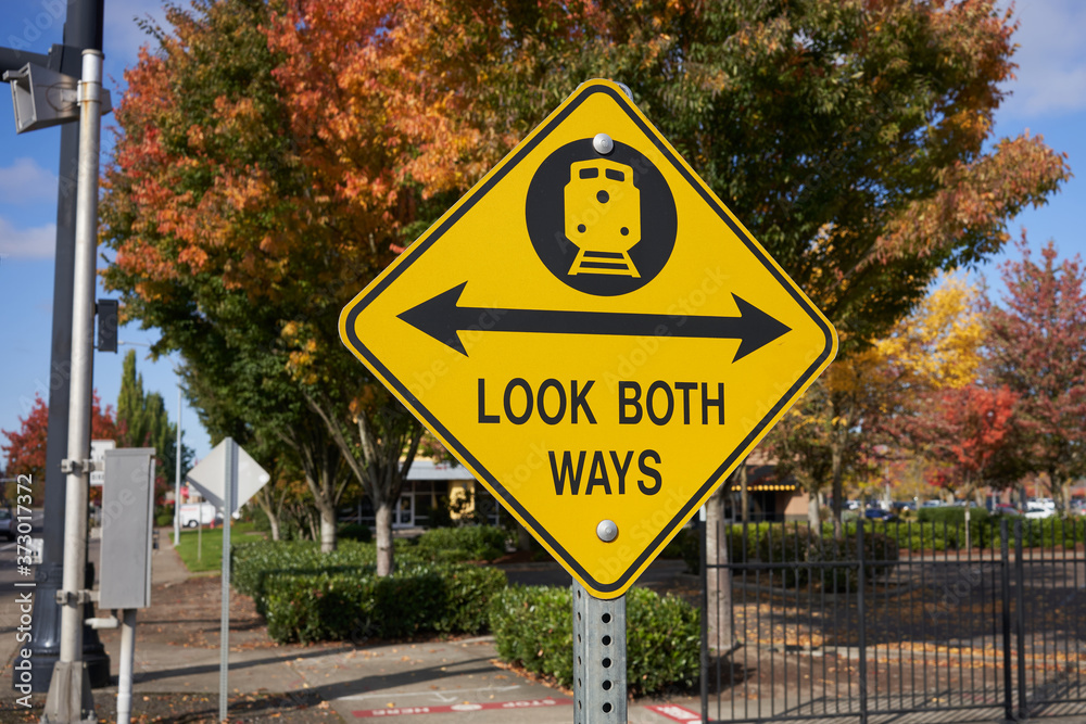 Look both ways warning sign at a railroad junction.