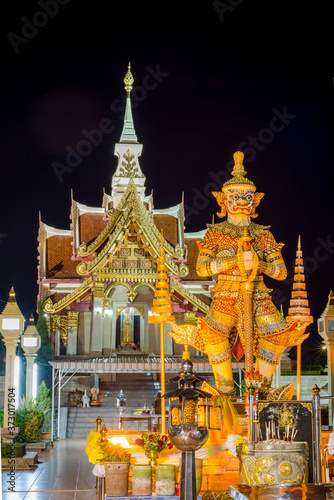 Thai Giant Statue in front of Pillar Shrine in Udon thani province,Thailand, Nightime. They are public domain or treasure of Buddhism, no restrict in copy of use. soft focus.