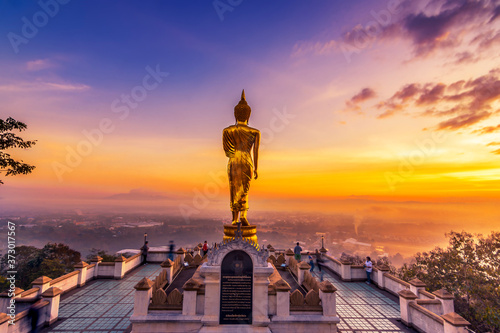 Golden buddha statue in Khao Noi temple at sunrise, Nan Province, Thailand