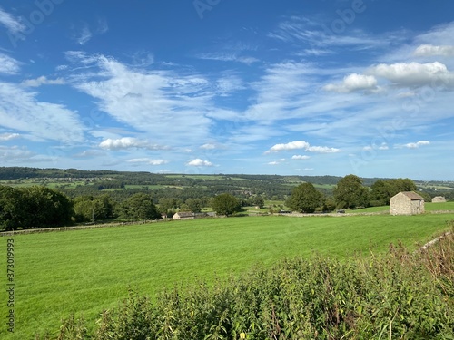 Landscape view of fields, and an old stone barn, in an extensive meadow in, West Witton, Leyburn, UK photo