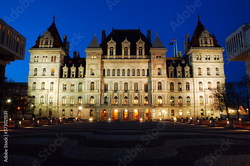 The New York State Capitol Building is illuminated at dusk