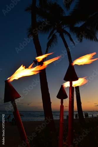 Traditional torches burn at dusk on Waikiki Bech