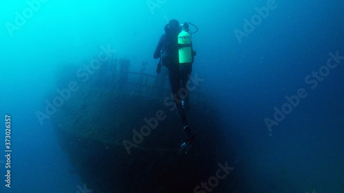 Diver looking at shipwreck