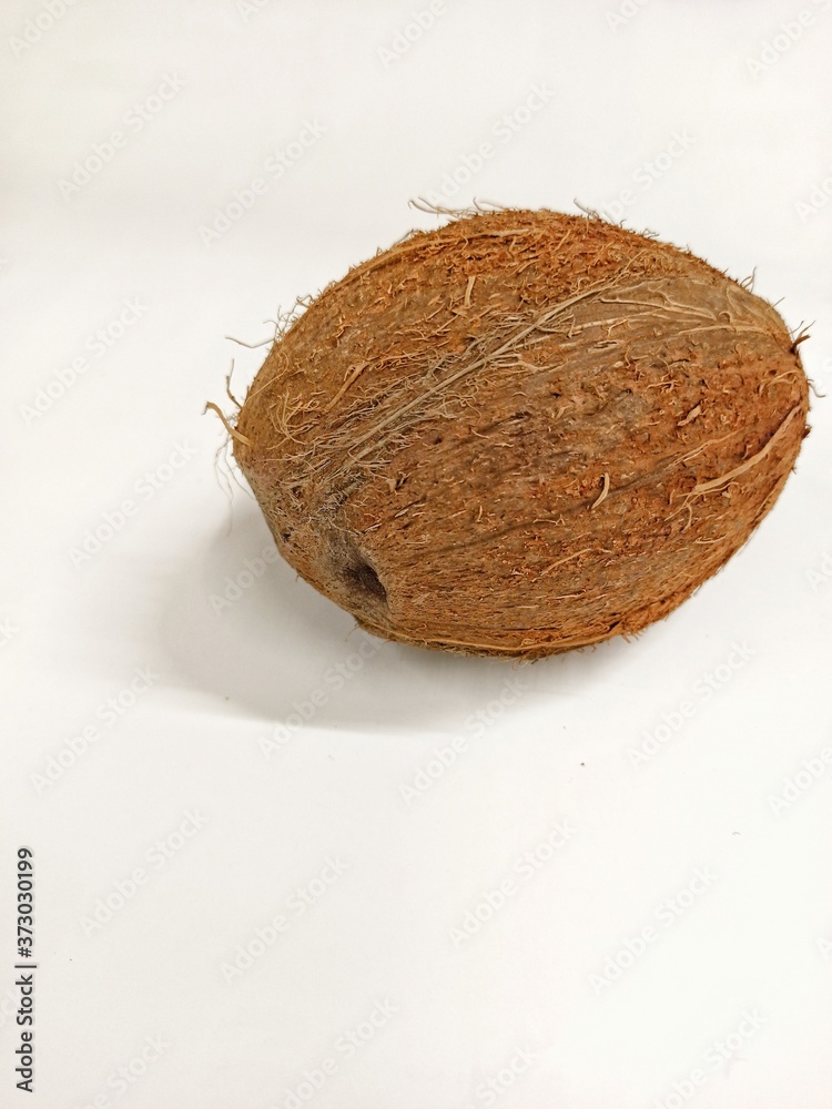Photo of a whole coconut close up isolated on a white background Photo of a whole coconut close up isolated on a white background