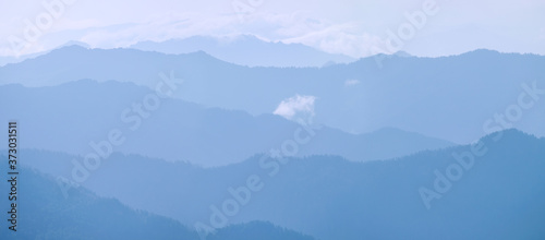 Mountains in the morning haze, blue natural background © Valerii