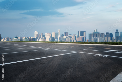 Empty asphalt road along modern commercial buildings in China  s cities