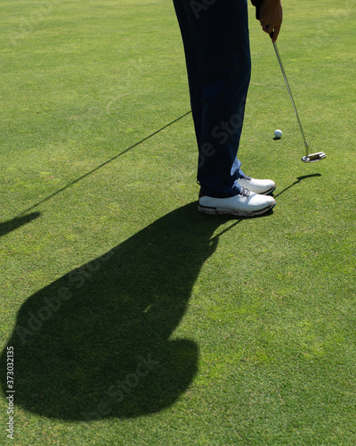 A person playing golf.  photo