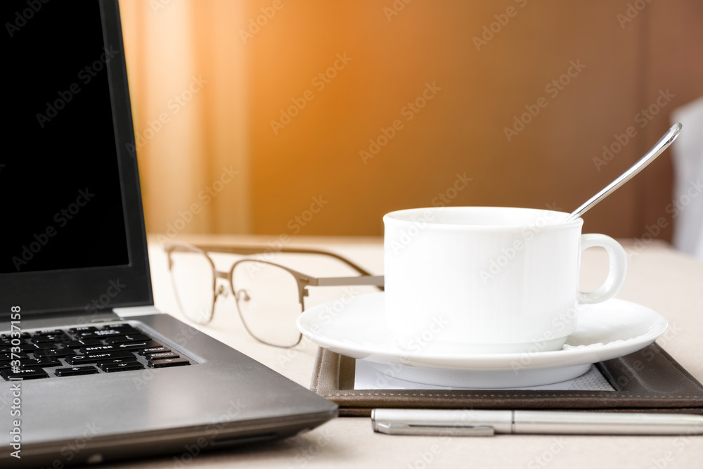 Working from home with laptop glasses pen and coffee cup hot in the morning. Workspace background composition with space for text. Enjoy love relax time during working at home with copy space. Working from home with laptop glasses pen and coffee cup hot in the morning. Workspace background composition with space for text. Enjoy love relax time during working at home with copy space.
