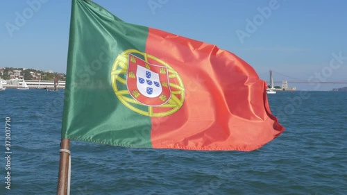 portuguese flag waving with the wind in boat at sea