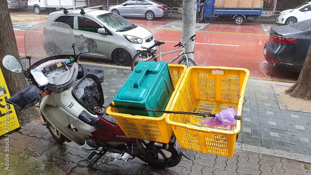 Delivery motorcycle parked on the street in Korea. Convenient service in south Korea. Delivery motorcycle parked on the street in Korea. Convenient service in south Korea.